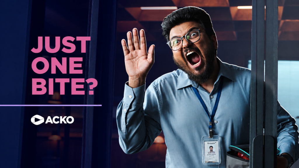 ACKO Just One Bite campaign showing a startled man raising one hand.