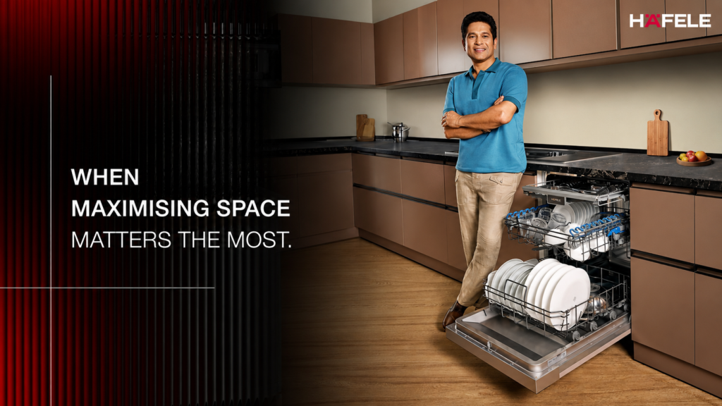 Häfele campaign showing a man standing in a kitchen beside an open dishwasher.