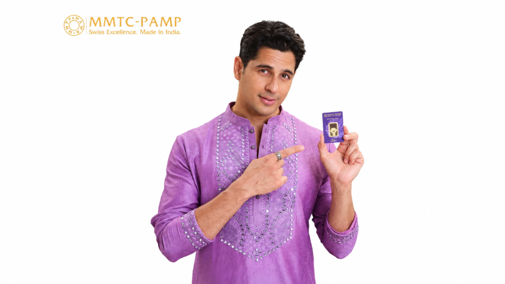 MMTC-PAMP campaign showing a man in a purple kurta holding a gold-product package.