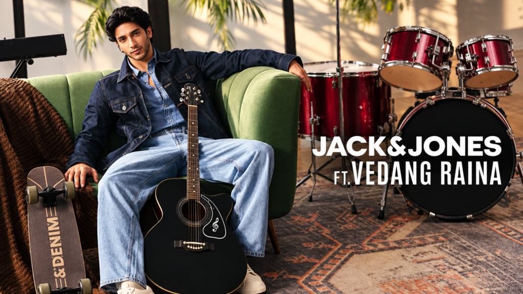 JACK & JONES denim campaign with a seated model beside a guitar and drum kit.