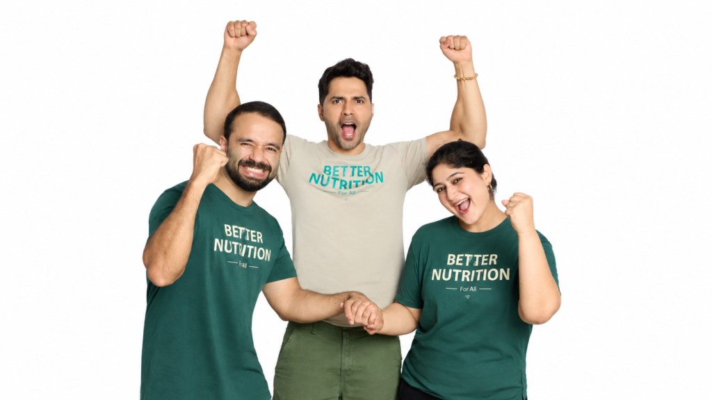 Three men wearing Better Nutrition shirts, with one lifting another in celebration.