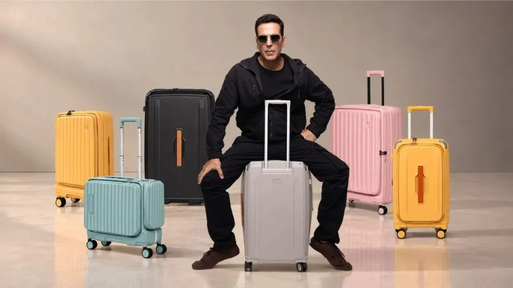 Acer luggage campaign featuring a man in black surrounded by colourful suitcases.