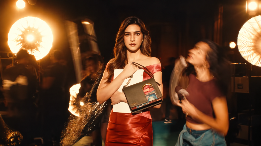 Zouk campaign showing a woman holding a handbag in a studio setting.